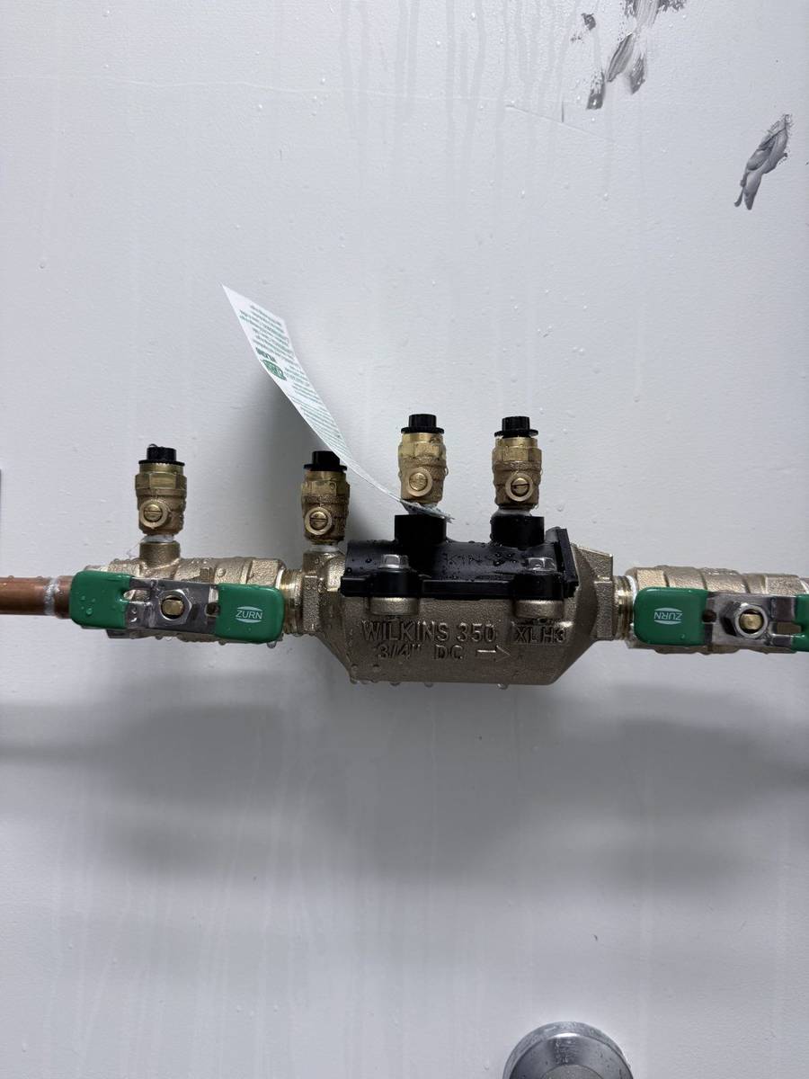 Technician performing an annual backflow prevention test