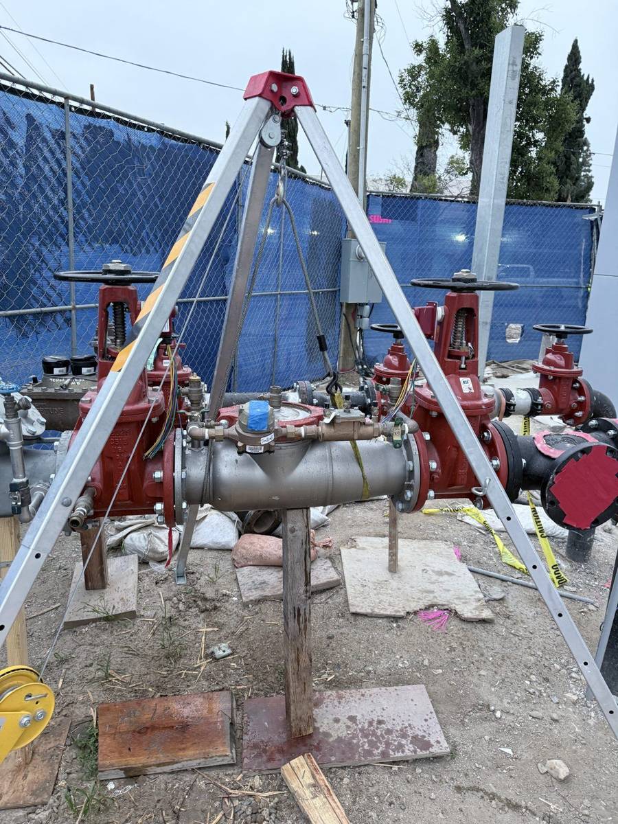 Certified backflow assembly testing in progress on a commercial property